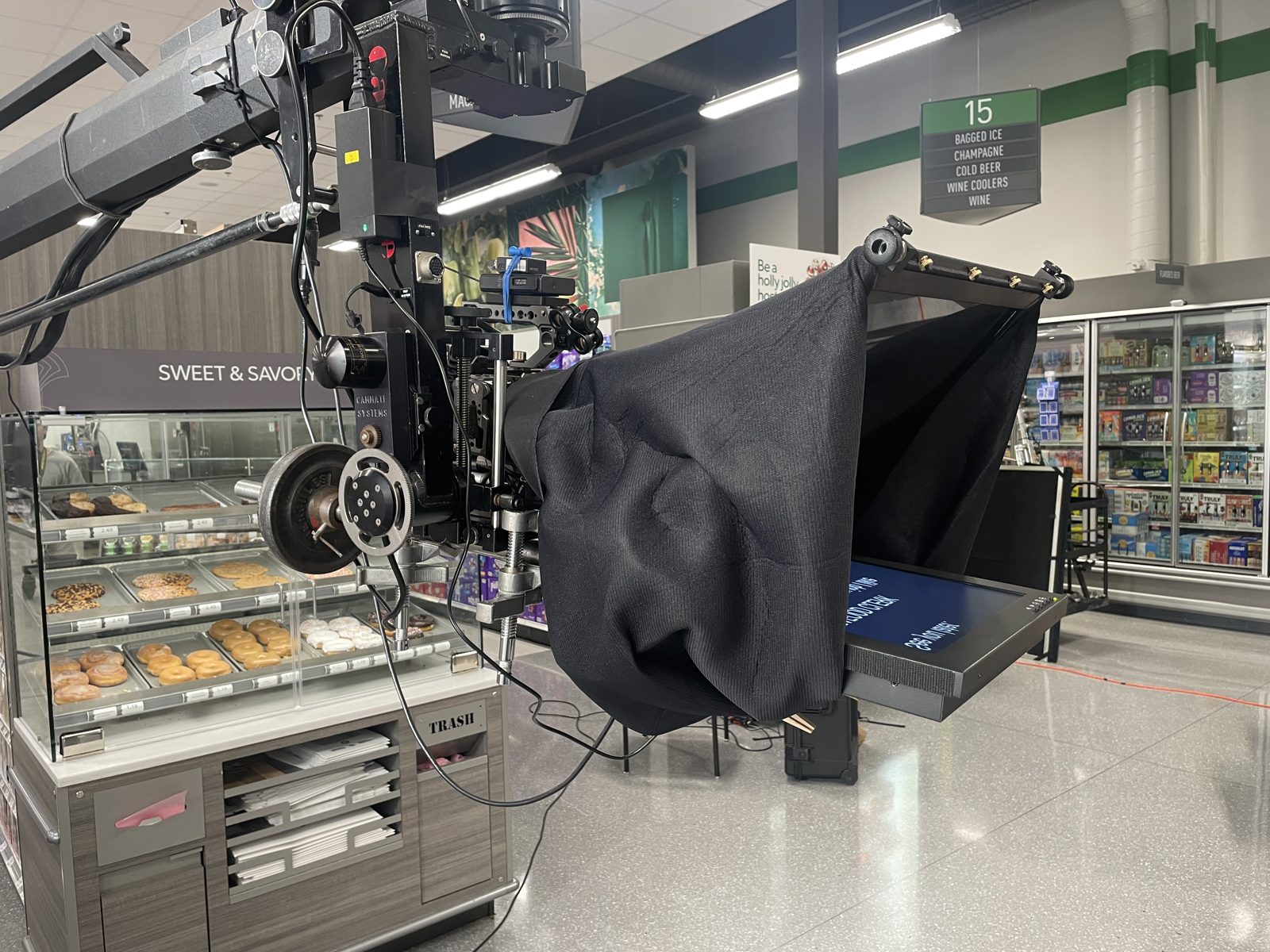 Camera crane and softbox lighting rig on a retail production set