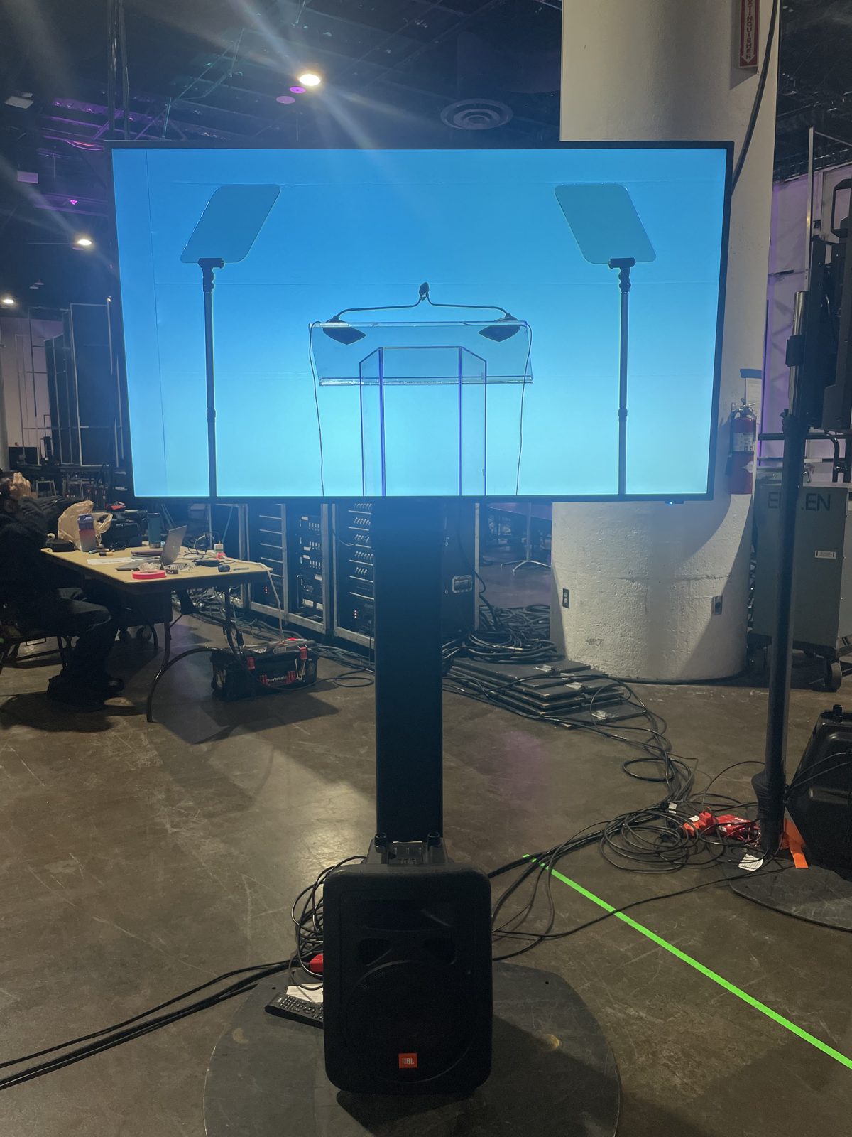 Teleprompter display on a stand with blue screen at a conference